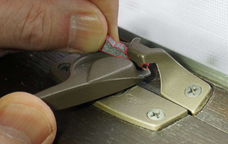 DRAFTeeze installation step 3 – hold DRAFTeeze with left hand, swing the crescent lock with right hand